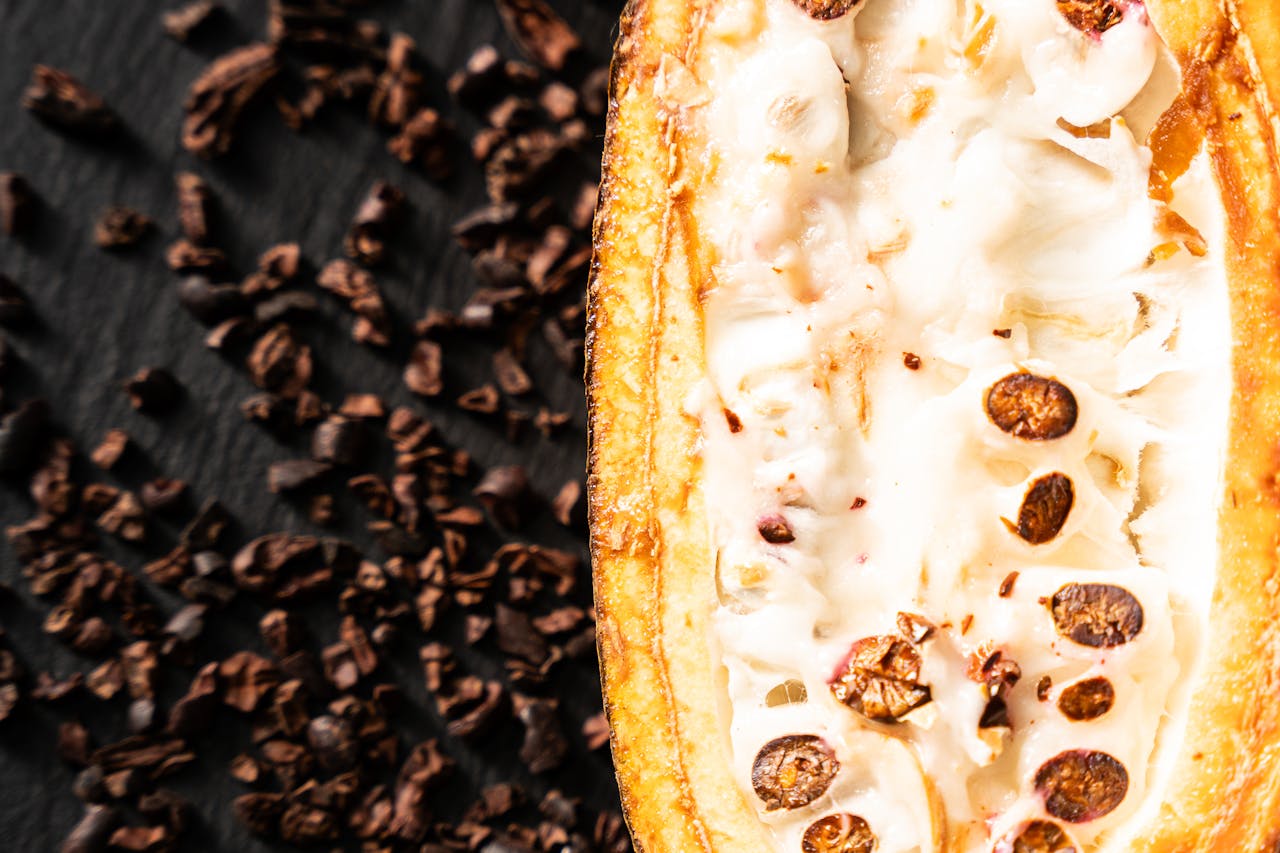 Detailed image of a cacao pod split open showing cocoa beans, highlighting the natural textures.